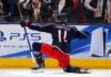 Adam Fantilli of the Columbus Blue Jackets celebrates a goal in front of the crowd as a stylish PS5 rink board ad highlights his 2026-27 fantasy hockey breakout outlook.