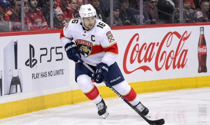 aleksander-barkov-florida-panthers-fantasy-projection-2026-27 Aleksander Barkov skating with the puck for the Florida Panthers ahead of the 2026-27 NHL season and fantasy hockey comeback.