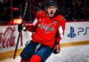 Alex Ovechkin Point Projections 2026-27: Washington Capitals Fantasy Outlook Alex Ovechkin celebrating for the Washington Capitals beside Coca-Cola and PS5 board ads in a 2026-27 fantasy hockey point projection.