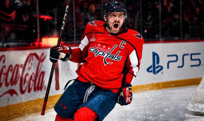 alex-ovechkin-washington-capitals-fantasy-hockey-projection-2026-27 Alex Ovechkin celebrating for the Washington Capitals beside Coca-Cola and PS5 board ads in a 2026-27 fantasy hockey point projection.
