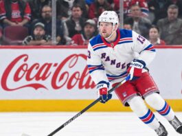 Alexis Lafrenière skating for the New York Rangers as trade rumors surround the young winger ahead of the 2026-27 NHL season.