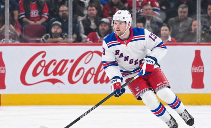 alexis-lafreniere-new-york-rangers-trade-rumors-featured-image Alexis Lafrenière skating for the New York Rangers as trade rumors surround the young winger ahead of the 2026-27 NHL season.