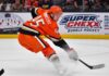 Beckett Sennecke of the Anaheim Ducks skates with the puck during game action beside a Super Chexx Bubble Hockey board ad in a 2026-27 fantasy hockey projection post