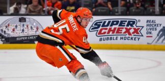 Beckett Sennecke of the Anaheim Ducks skates with the puck during game action beside a Super Chexx Bubble Hockey board ad in a 2026-27 fantasy hockey projection post