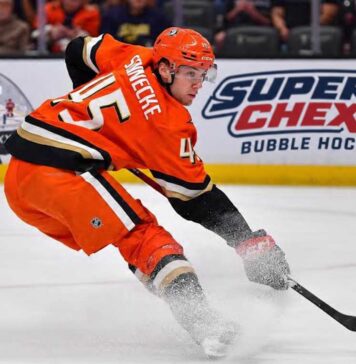 Beckett Sennecke of the Anaheim Ducks skates with the puck during game action beside a Super Chexx Bubble Hockey board ad in a 2026-27 fantasy hockey projection post