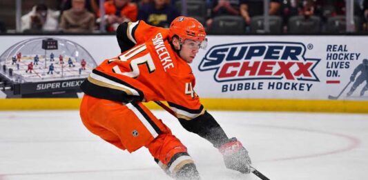 Beckett Sennecke of the Anaheim Ducks skates with the puck during game action beside a Super Chexx Bubble Hockey board ad in a 2026-27 fantasy hockey projection post