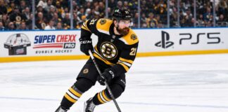 Filip Hronek in a Boston Bruins home jersey skates during a concept image as Boston Bruins trade rumors link the Vancouver Canucks defenceman to Boston.