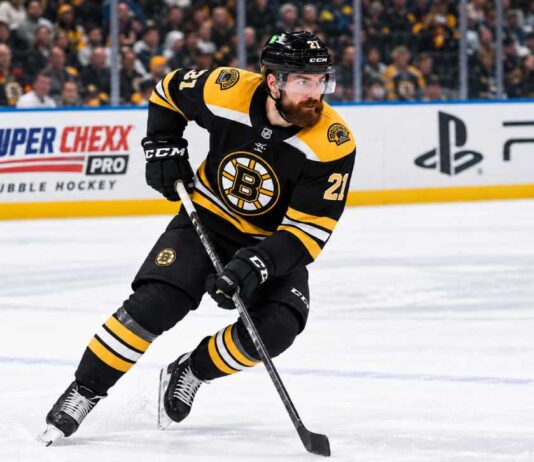 Filip Hronek in a Boston Bruins home jersey skates during a concept image as Boston Bruins trade rumors link the Vancouver Canucks defenceman to Boston.