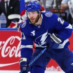 Brayden Point Fantasy Hockey Projection: Is an 86-Point Bounce-Back Coming? Tampa Bay Lightning forward skating on the ice in front of a stylish Coca-Cola boards ad in a Brayden Point fantasy hockey projection post