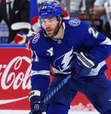 Brayden Point Fantasy Hockey Projection: Is an 86-Point Bounce-Back Coming? Tampa Bay Lightning forward skating on the ice in front of a stylish Coca-Cola boards ad in a Brayden Point fantasy hockey projection post