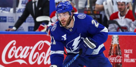 Brayden Point Fantasy Hockey Projection: Is an 86-Point Bounce-Back Coming? Tampa Bay Lightning forward skating on the ice in front of a stylish Coca-Cola boards ad in a Brayden Point fantasy hockey projection post