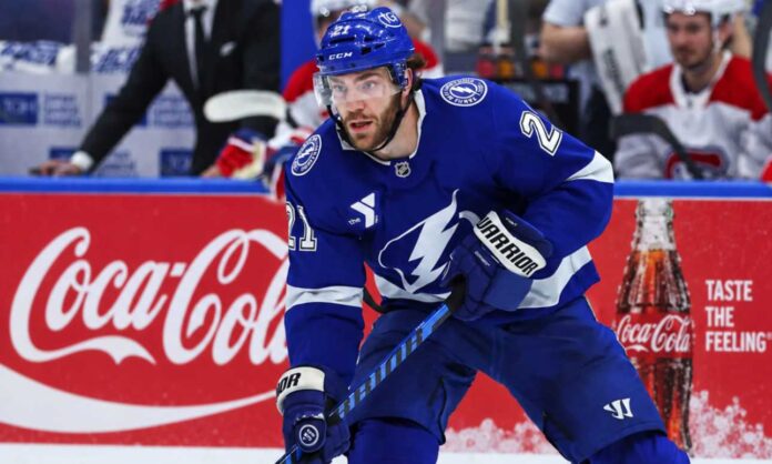 brayden-point-tampa-bay-lightning-fantasy-hockey-2026-27 Tampa Bay Lightning forward skating on the ice in front of a stylish Coca-Cola boards ad in a Brayden Point fantasy hockey projection post