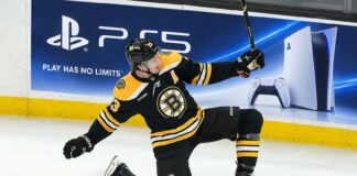 Charlie McAvoy of the Boston Bruins celebrates on the ice during a game as his 2026-27 fantasy hockey projection highlights his scoring upside and power-play value.