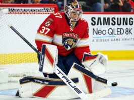 Florida Panthers goalie concept image tied to Connor Hellebuyck trade rumors, showing a goaltender in Florida Panthers gear in the crease with a Samsung TV ad on the boards.