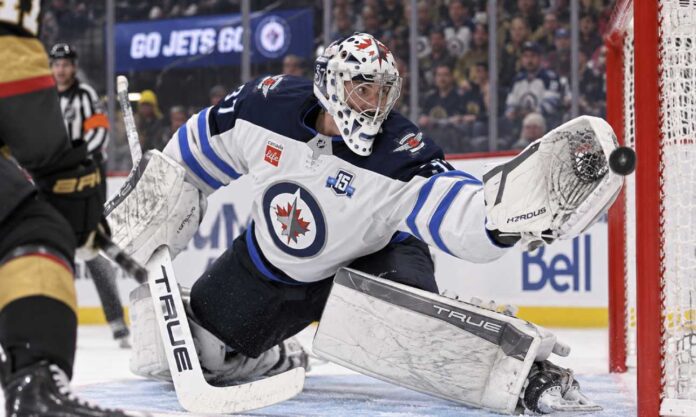 connor-hellebuyck-montreal-canadiens-trade-rumors-2026 Connor Hellebuyck of the Winnipeg Jets makes a save against the Vegas Golden Knights amid NHL trade rumors linking him to Montreal.