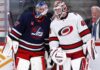 Is Connor Hellebuyck Finally Moving? Carolina May Hold the Trade Piece Winnipeg Wants Connor Hellebuyck of the Winnipeg Jets talks with a Carolina Hurricanes goalie during NHL trade rumor speculation linking Hellebuyck to Carolina