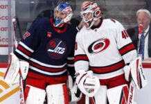 Is Connor Hellebuyck Finally Moving? Carolina May Hold the Trade Piece Winnipeg Wants Connor Hellebuyck of the Winnipeg Jets talks with a Carolina Hurricanes goalie during NHL trade rumor speculation linking Hellebuyck to Carolina