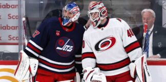 Is Connor Hellebuyck Finally Moving? Carolina May Hold the Trade Piece Winnipeg Wants Connor Hellebuyck of the Winnipeg Jets talks with a Carolina Hurricanes goalie during NHL trade rumor speculation linking Hellebuyck to Carolina