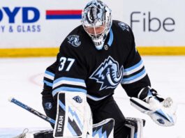 Connor Hellebuyck in a Utah Mammoth uniform and goalie equipment during warmups, illustrating Winnipeg Jets and Utah Mammoth trade rumors
