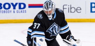 Connor Hellebuyck in a Utah Mammoth uniform and goalie equipment during warmups, illustrating Winnipeg Jets and Utah Mammoth trade rumors
