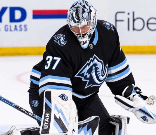Connor Hellebuyck in a Utah Mammoth uniform and goalie equipment during warmups, illustrating Winnipeg Jets and Utah Mammoth trade rumors