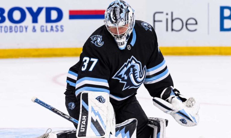 Connor Hellebuyck in a Utah Mammoth uniform and goalie equipment during warmups, illustrating Winnipeg Jets and Utah Mammoth trade rumors