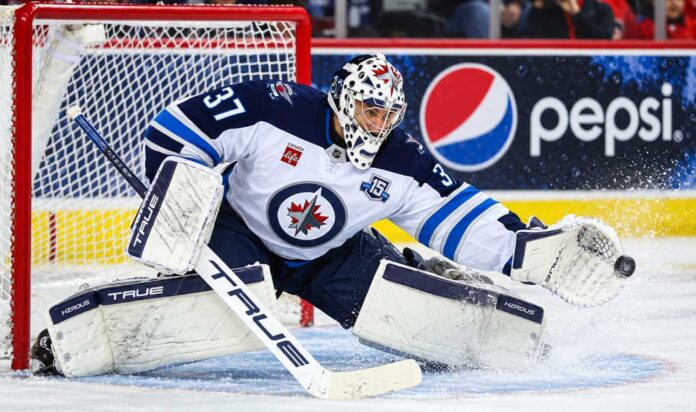 connor-hellebuyck-winnipeg-jets-trade-rumors-return Connor Hellebuyck makes a save for the Winnipeg Jets as trade rumors grow over a possible return to Winnipeg.