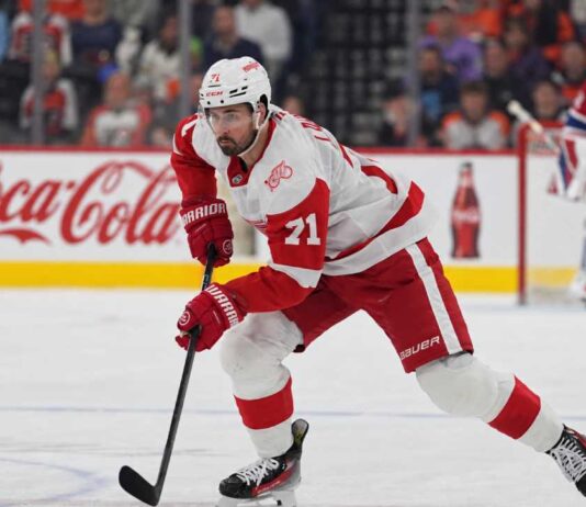 Dylan Larkin of the Detroit Red Wings skates in front of a Montreal Canadiens goalie during NHL trade rumors linking Larkin to Montreal
