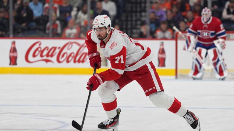 Dylan Larkin of the Detroit Red Wings skates in front of a Montreal Canadiens goalie during NHL trade rumors linking Larkin to Montreal