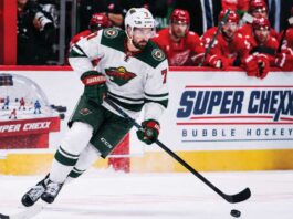Dylan Larkin in a Minnesota Wild away jersey during NHL trade rumor speculation involving the Detroit Red Wings and Minnesota Wild.