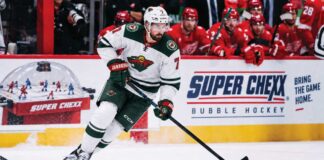 Dylan Larkin Trade Rumors: Did the Red Wings Just Push Him Closer to the Minnesota Wild? Dylan Larkin in a Minnesota Wild away jersey during NHL trade rumor speculation involving the Detroit Red Wings and Minnesota Wild.