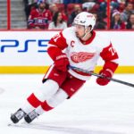 Montreal Canadiens Trade Rumors: Is Montreal Still Chasing Dylan Larkin Despite His Expanded Trade List? Dylan Larkin of the Detroit Red Wings skating past Montreal Canadiens fans as Canadiens trade rumors continue to link him to Montreal.