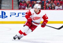 Montreal Canadiens Trade Rumors: Is Montreal Still Chasing Dylan Larkin Despite His Expanded Trade List? Dylan Larkin of the Detroit Red Wings skating past Montreal Canadiens fans as Canadiens trade rumors continue to link him to Montreal.