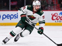 Dylan Larkin in a Minnesota Wild away uniform concept image amid NHL trade rumors linking the Detroit Red Wings centre to Minnesota.