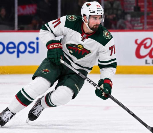 Dylan Larkin in a Minnesota Wild away uniform concept image amid NHL trade rumors linking the Detroit Red Wings centre to Minnesota.