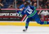 Elias Pettersson Trade Rumors: Is the Door Back Open for the Los Angeles Kings? Elias Pettersson of the Vancouver Canucks takes a powerful shot in action as a Super Chexx bubble hockey board ad appears behind him amid Los Angeles Kings trade rumors.