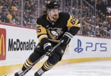 Erik Karlsson Fantasy Hockey Prediction: Can He Reach 70 Points Again in 2026-27? Erik Karlsson of the Pittsburgh Penguins skates along the boards during game action, highlighting his 2026-27 fantasy hockey outlook