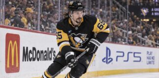Erik Karlsson Fantasy Hockey Prediction: Can He Reach 70 Points Again in 2026-27? Erik Karlsson of the Pittsburgh Penguins skates along the boards during game action, highlighting his 2026-27 fantasy hockey outlook