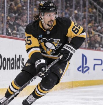 Erik Karlsson of the Pittsburgh Penguins skates along the boards during game action, highlighting his 2026-27 fantasy hockey outlook