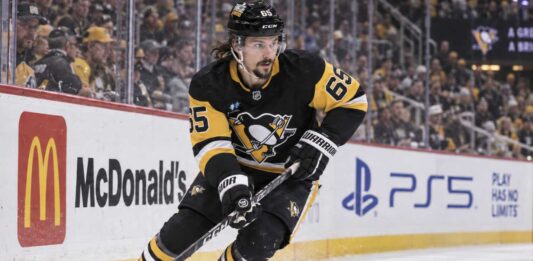 Erik Karlsson of the Pittsburgh Penguins skates along the boards during game action, highlighting his 2026-27 fantasy hockey outlook