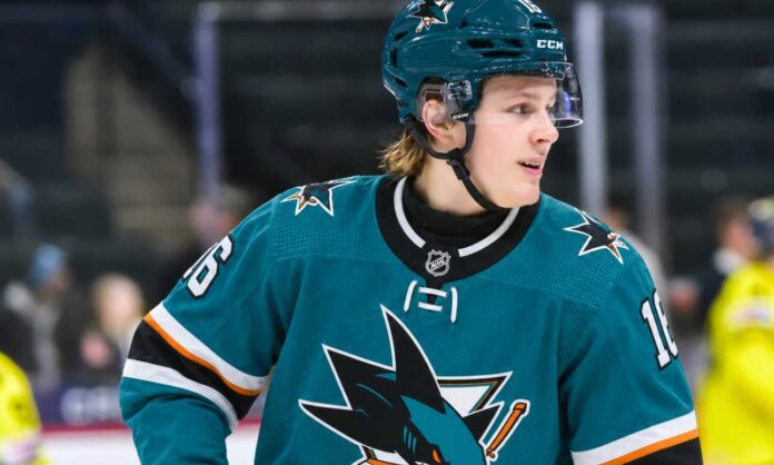 ivar-stenberg-san-jose-sharks-fantasy-hockey-2026-27 Ivar Stenberg wearing a San Jose Sharks home jersey and helmet in an action-style image for a 2026-27 fantasy hockey prediction