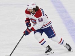 Kirill Marchenko in a Montreal Canadiens uniform skates with the puck in a concept image illustrating Montreal Canadiens trade rumors involving the Columbus Blue Jackets winger.