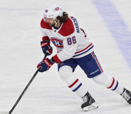 Kirill Marchenko in a Montreal Canadiens uniform skates with the puck in a concept image illustrating Montreal Canadiens trade rumors involving the Columbus Blue Jackets winger.
