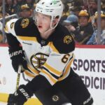 Mason Lohrei Trade Rumors: Why the Boston Bruins Could Listen Before Training Camp Boston Bruins defenseman skating with the puck during NHL game action as Boston Bruins trade rumors heat up before training camp