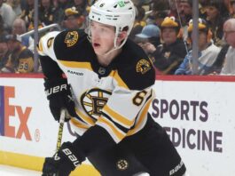 Mason Lohrei Trade Rumors: Why the Boston Bruins Could Listen Before Training Camp Boston Bruins defenseman skating with the puck during NHL game action as Boston Bruins trade rumors heat up before training camp