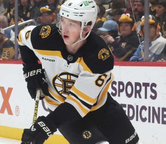 Mason Lohrei Trade Rumors: Why the Boston Bruins Could Listen Before Training Camp Boston Bruins defenseman skating with the puck during NHL game action as Boston Bruins trade rumors heat up before training camp