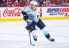 Matty Beniers Fantasy Hockey Projection 2026-27: Is a 63-Point Breakout Coming? Matty Beniers Seattle Kraken 2026-27 fantasy hockey projection with Coca-Cola and Super Chexx Bubble Hockey rink board ads