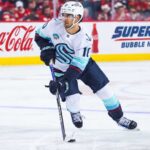 Matty Beniers Fantasy Hockey Projection 2026-27: Is a 63-Point Breakout Coming? Matty Beniers Seattle Kraken 2026-27 fantasy hockey projection with Coca-Cola and Super Chexx Bubble Hockey rink board ads