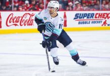 Matty Beniers Fantasy Hockey Projection 2026-27: Is a 63-Point Breakout Coming? Matty Beniers Seattle Kraken 2026-27 fantasy hockey projection with Coca-Cola and Super Chexx Bubble Hockey rink board ads