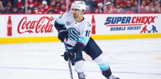 Matty Beniers Fantasy Hockey Projection 2026-27: Is a 63-Point Breakout Coming? Matty Beniers Seattle Kraken 2026-27 fantasy hockey projection with Coca-Cola and Super Chexx Bubble Hockey rink board ads